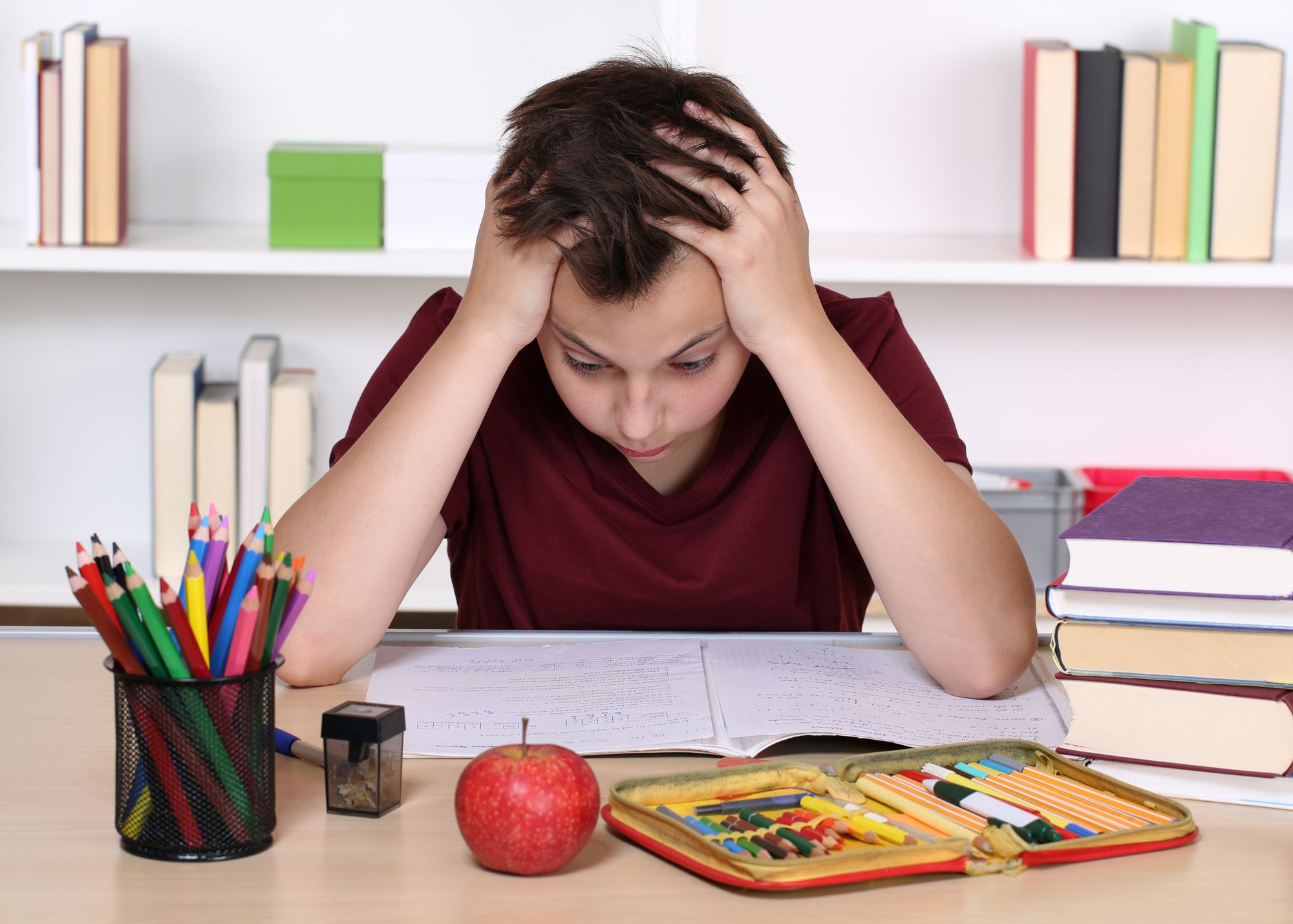 Boy feeling stressed doing school work